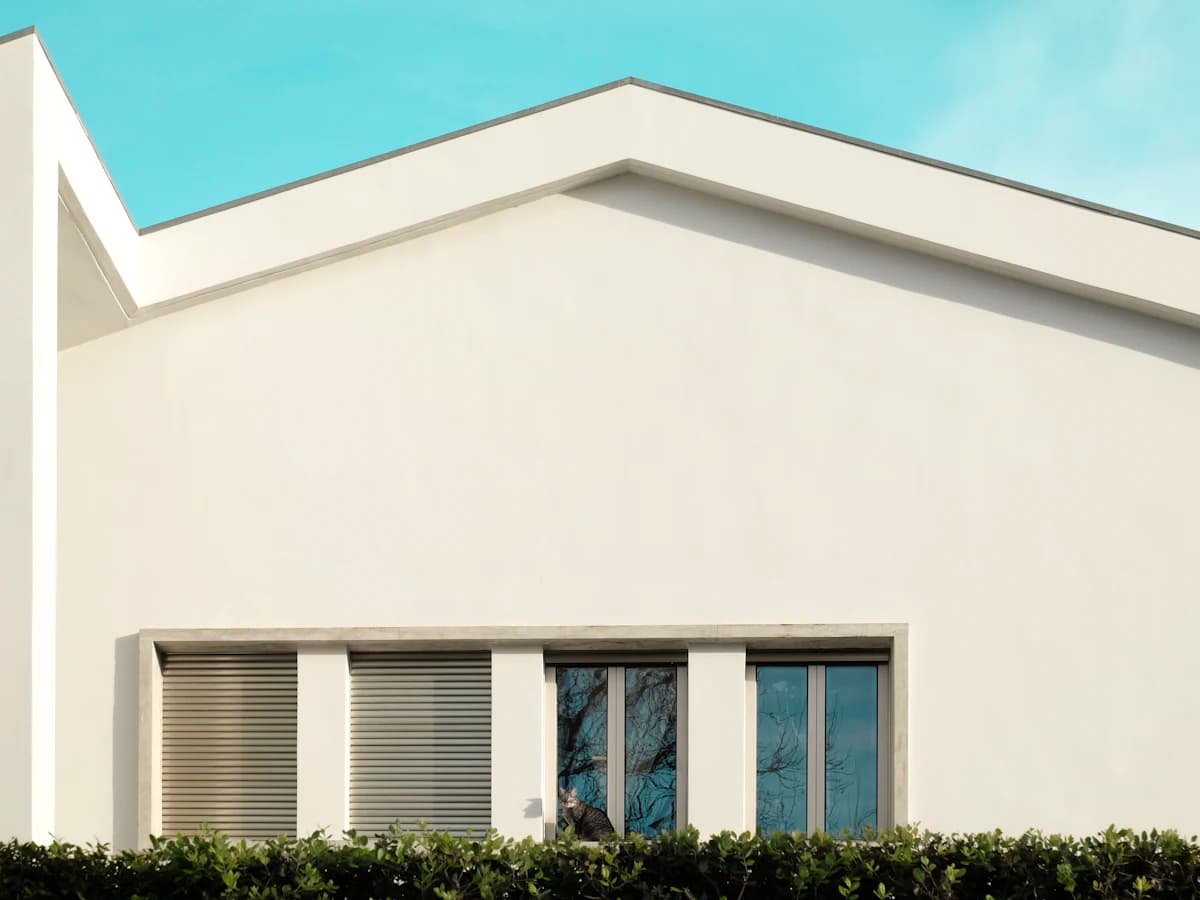 A white rendered house exterior in sunlight