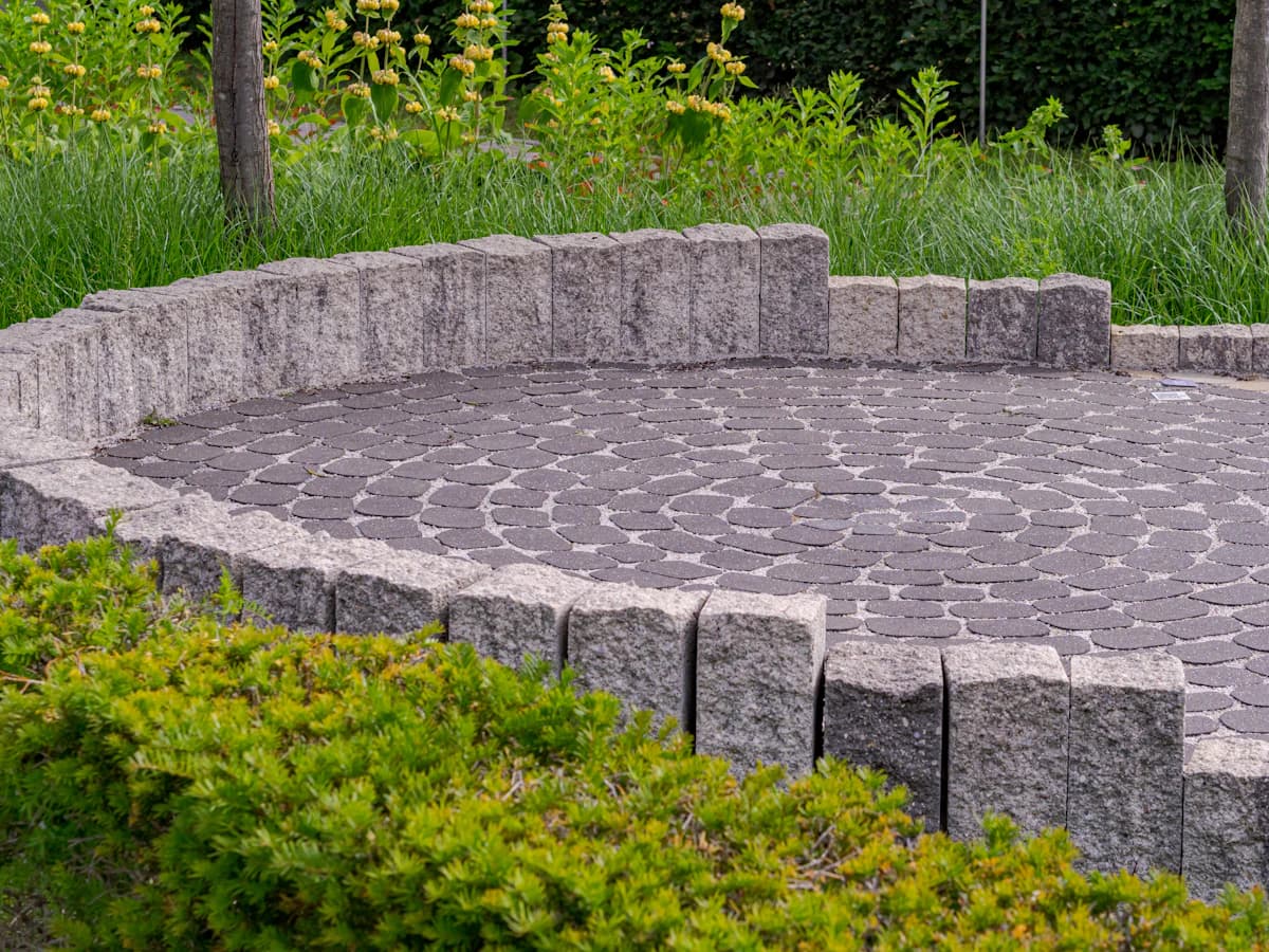 A paved backyard patio with outdoor furniture